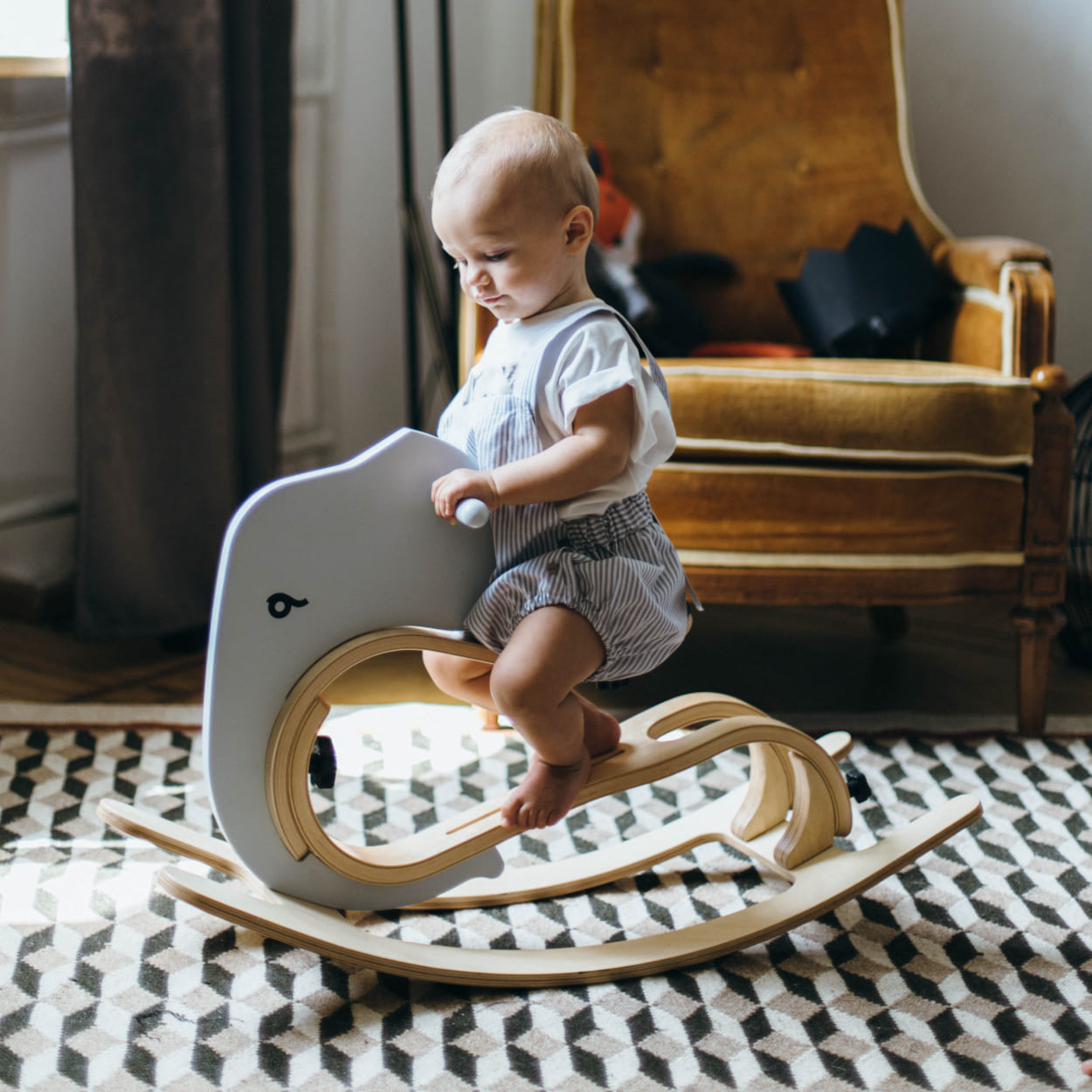 baby enjoying rocking elephant by leg&go