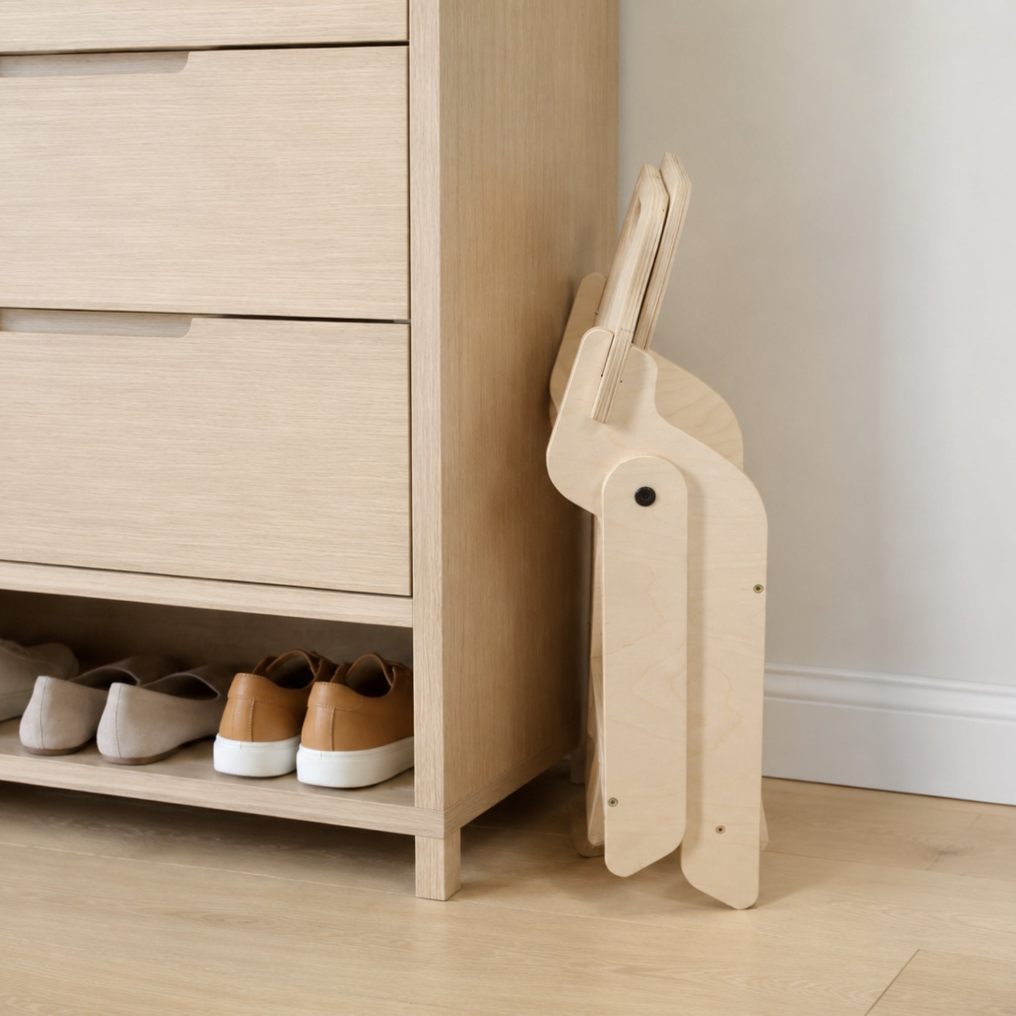 Foldable kids chair stored beside a cabinet to save space