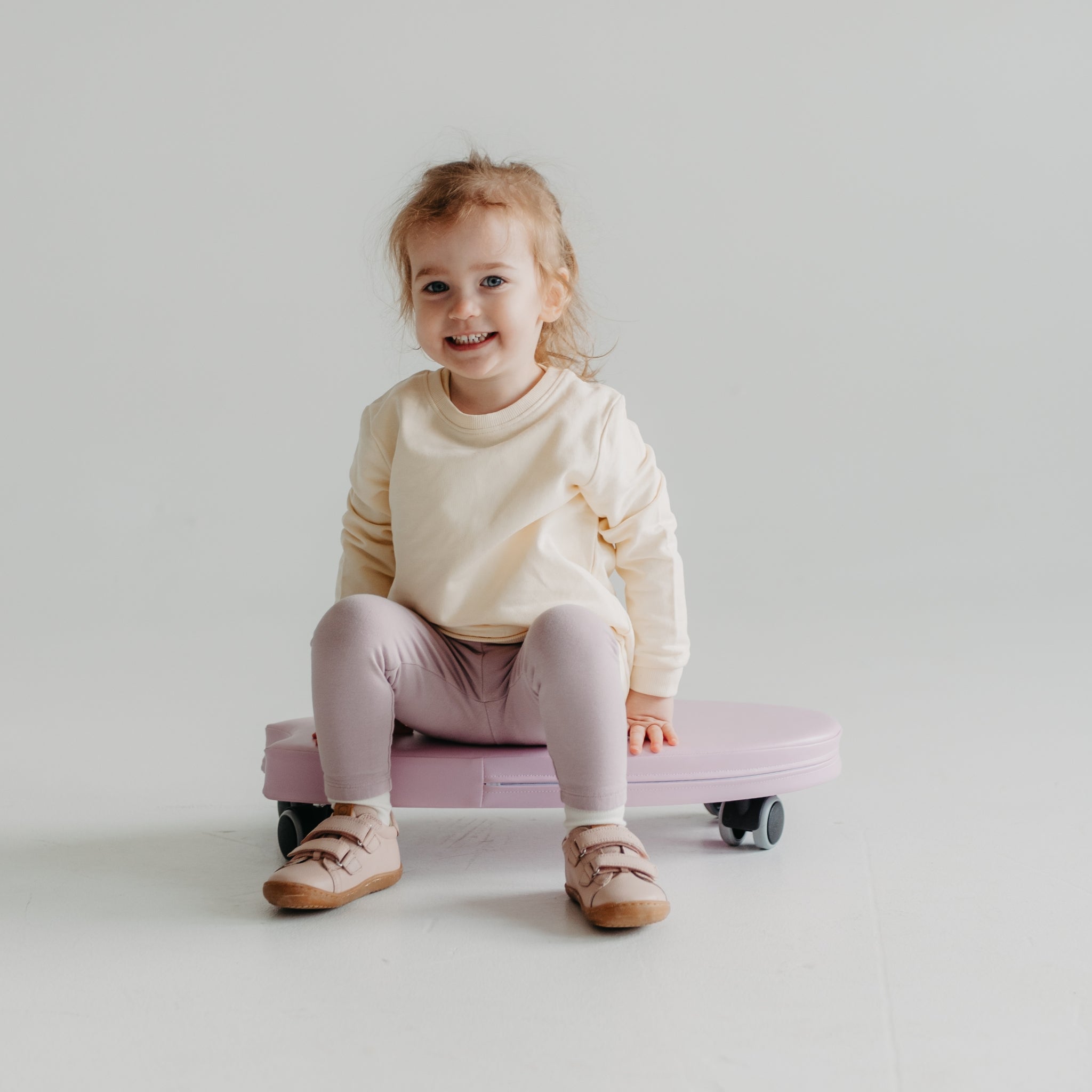 Toddler using foam ride on toy, safe indoor movement toy for children