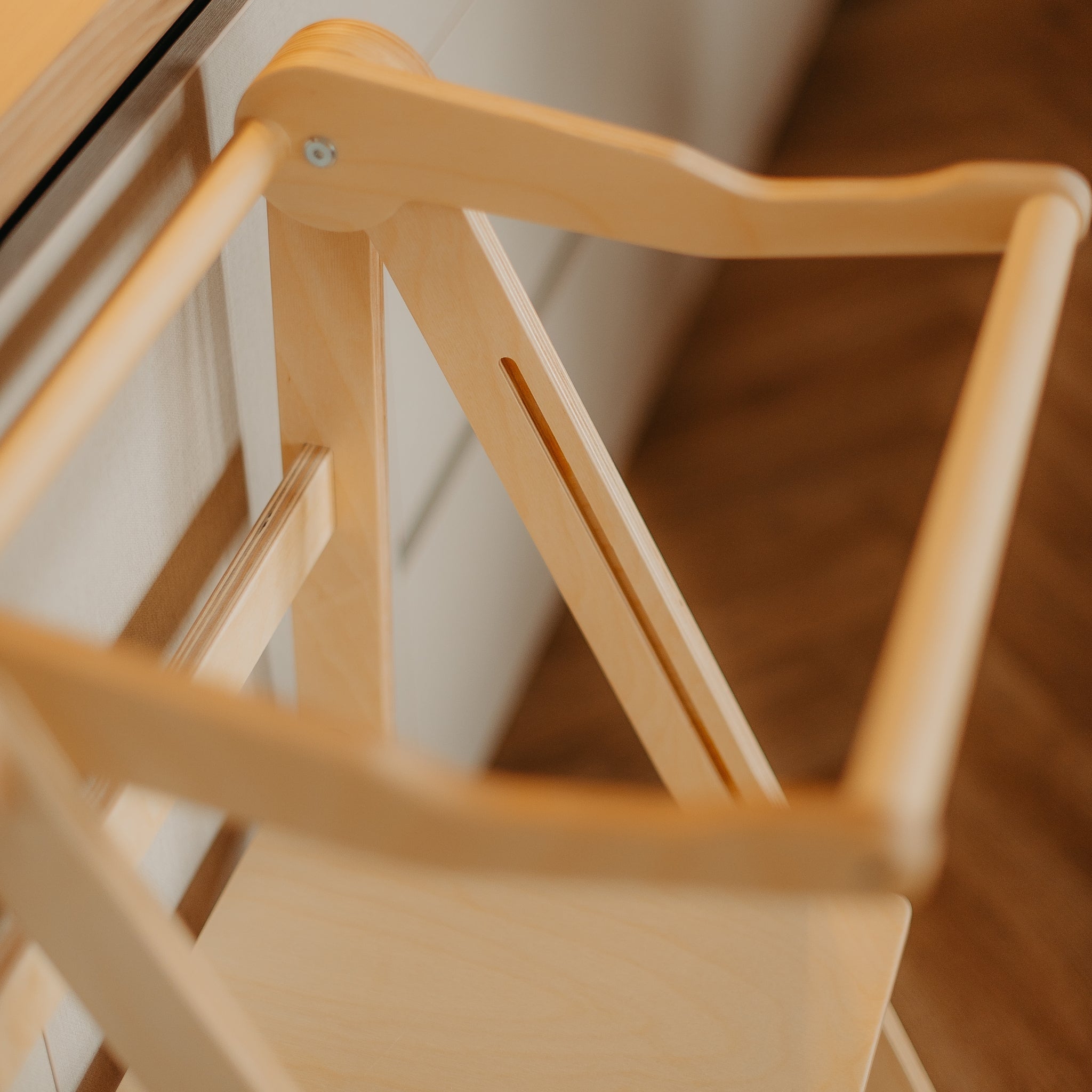 Close-up of wooden learning tower frame showing natural wood construction
